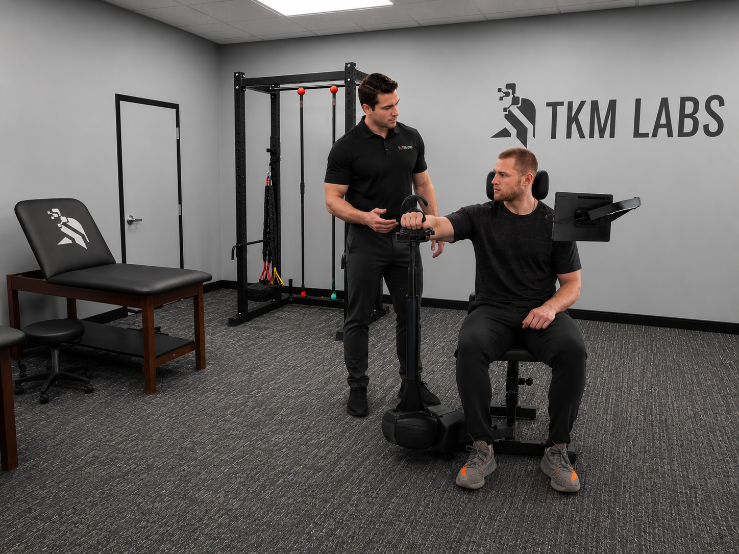 TKM Labs physical therapist guiding a patient through shoulder testing on the Humero Tech C1
